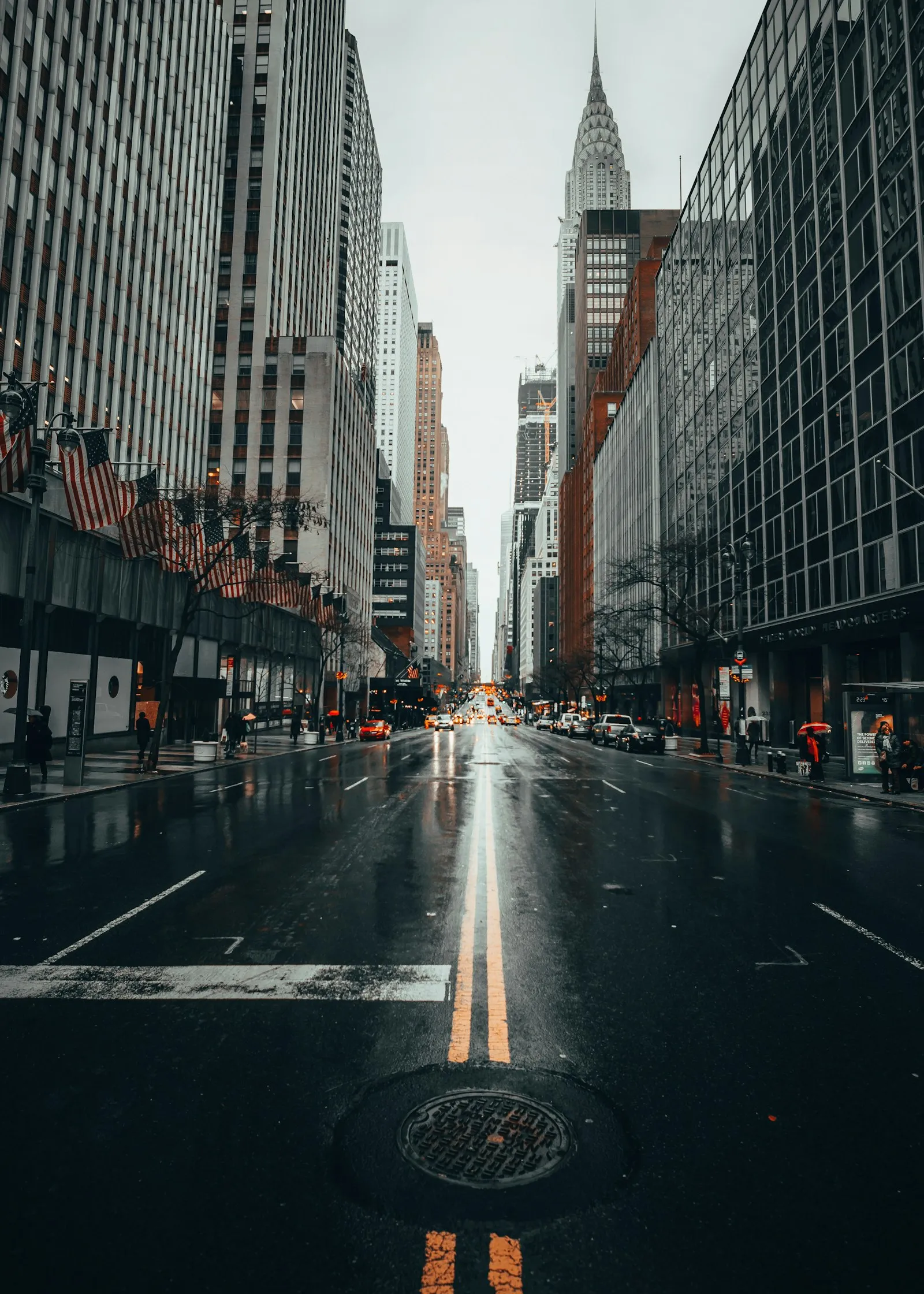 Wet city street with skyscrapers